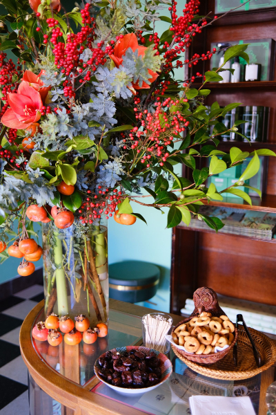 Flower arrangement and bowls of snacks on a table
